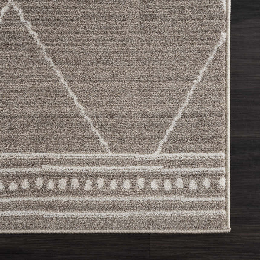 Close-up of the Kami Area Rug, dark beige and ivory, with a geometric Moroccan-inspired pattern. Swatch