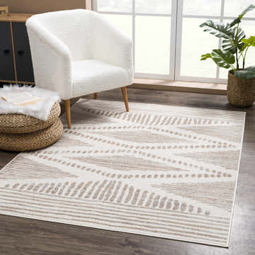 Living room scene with Tigrisis Beige 2328 Area Rug, ivory chair, woven ottoman, and plant near a window. Roomscene-Rectangle