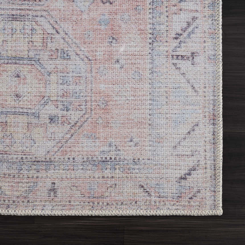 Close-up of the Morcott Peach Washable Area Rug showing its traditional, oriental-inspired design and soft peach, blue, and ivory colors. Swatch
