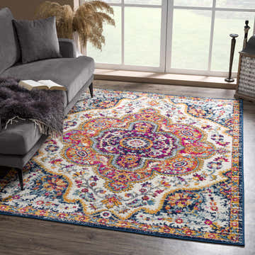Living room scene with a gray sofa and the colorful, vintage-style Simsbury Area Rug in dark blue, fuchsia, and orange. Roomscene-Rectangle