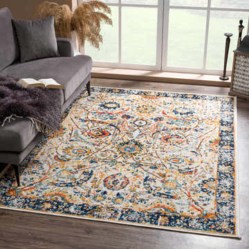 Living room scene with gray sofa and New Smyrna Area Rug in navy, orange, and mustard colors. Roomscene-Rectangle