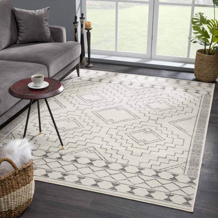 Living room scene with gray sofa and KMRSH-4614 Ivory Tribal Carpet, featuring a geometric gray pattern. Roomscene-Rectangle