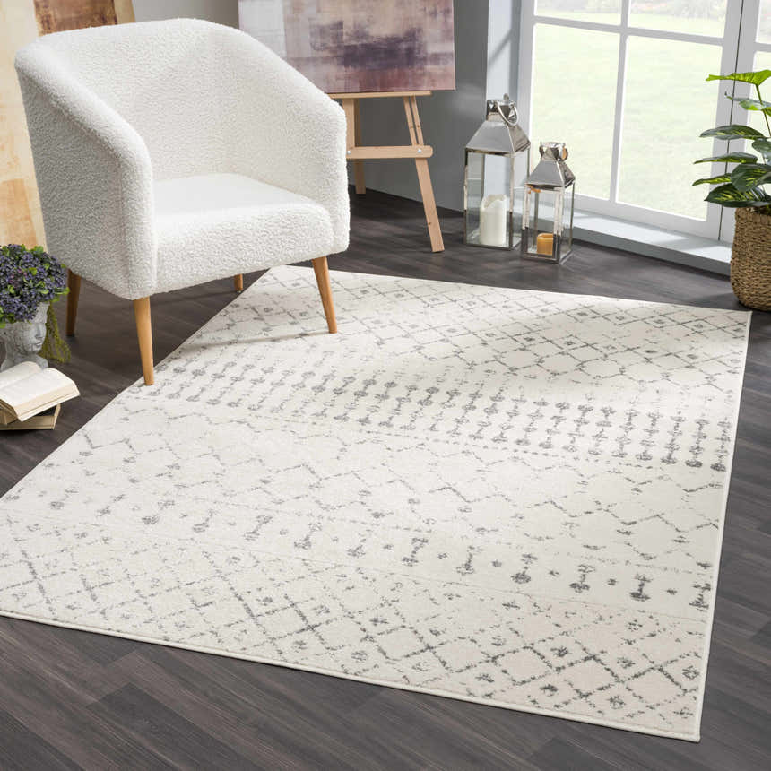 Living room scene with cream chair and Marash KMRSH-4606 area rug in cream and gray, adding a contemporary farmhouse style. Roomscene-Rectangle
