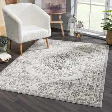 Living room scene with a white chair on a Marash KMRSH-4615 area rug in black, gray, and ivory. Roomscene-Rectangle