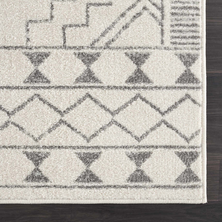 Close-up of the KMRSH-4614 Ivory Tribal Carpet. Features a gray geometric pattern on a textured ivory polypropylene rug. Corner