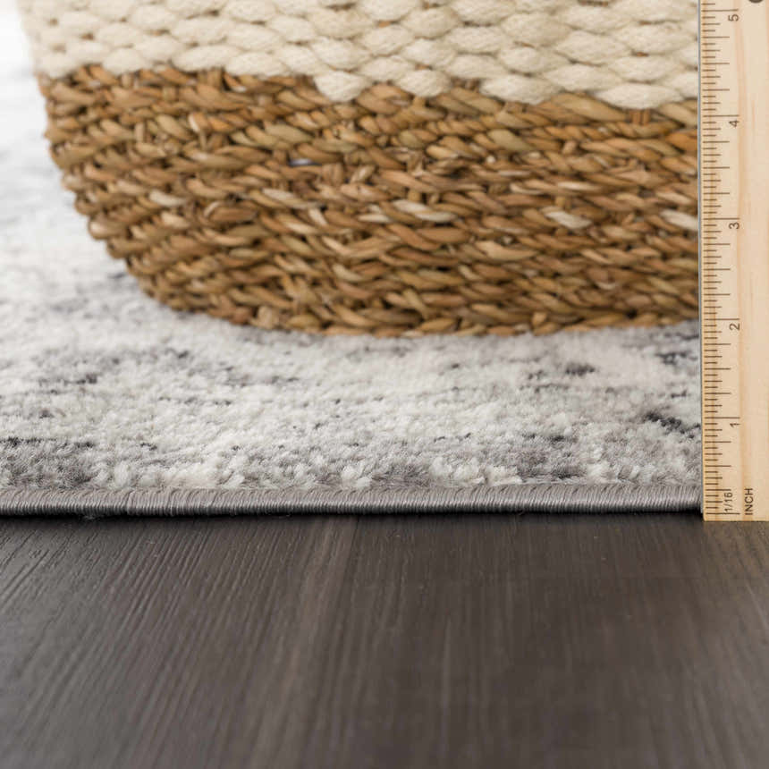 Close-up of the Marash KMRSH-4615 area rug showing the gray, ivory, and black pattern, texture, and rug thickness. Pile