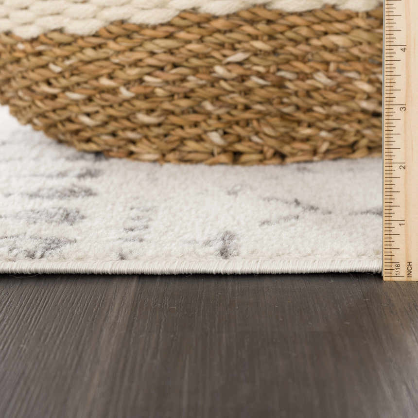 Close-up of Marash KMRSH-4606 rug showing cream and gray pattern, rug pile height, and rug thickness. Pile