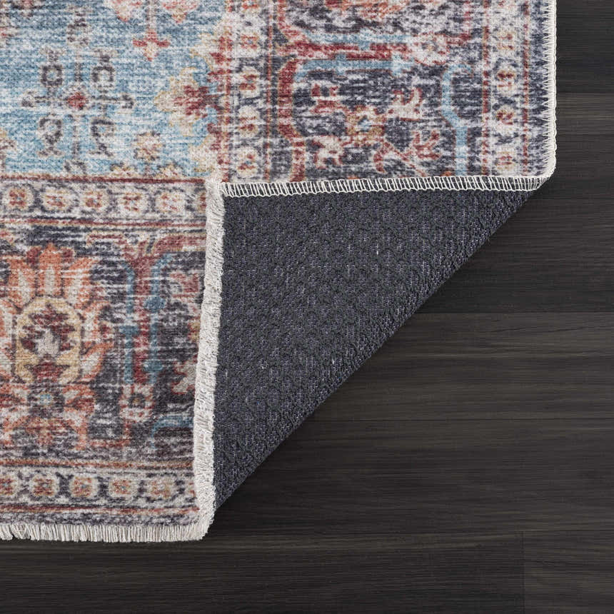 Close-up of Blue Burgundy Holi-2302 rug showing beige, blue, burgundy, and orange Persian-style pattern and non-slip backing. Fold