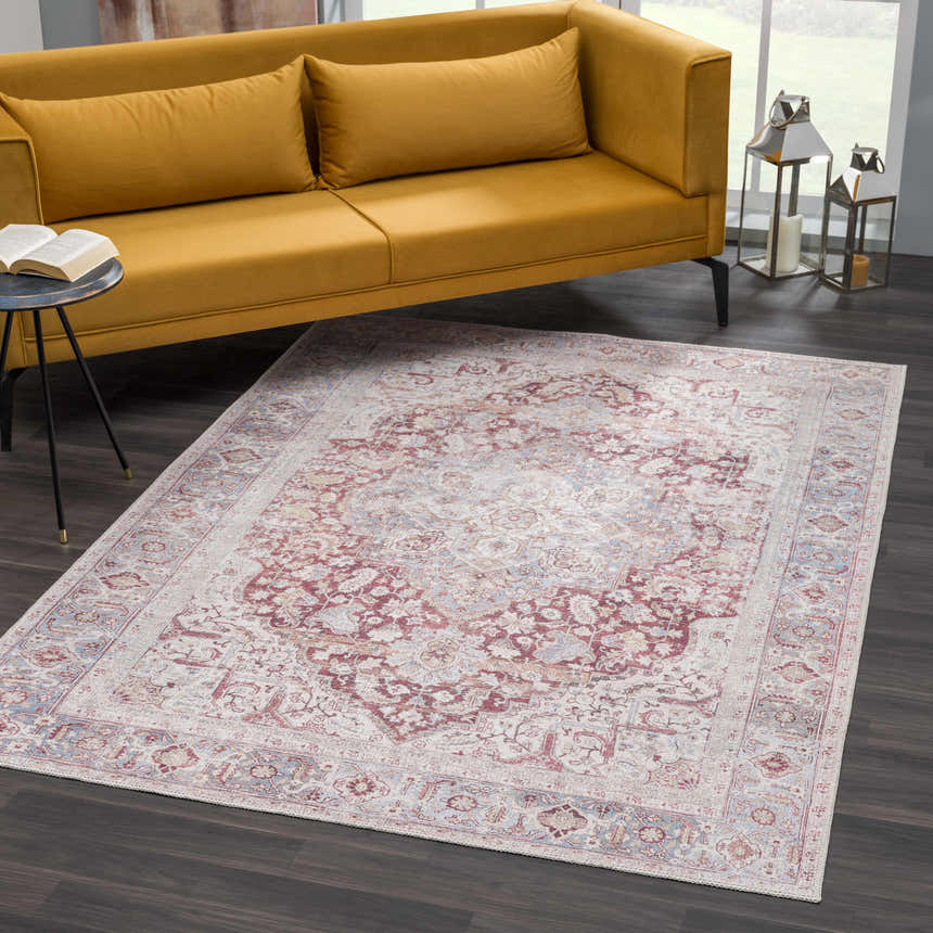 Living room scene with a Cream Rust Leeston Washable Rug, yellow sofa, dark wood floors, and a modern side table. Roomscene-Rectangle