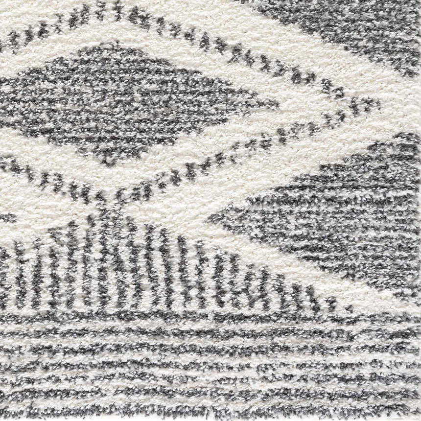 Close-up of Trunding Plush Area Rug showing charcoal and cream shag texture with a Moroccan-inspired geometric pattern. Swatch