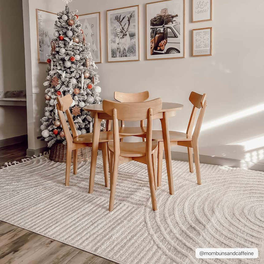 Dining room with Christmas tree and a light wood table on the Dauin 3D Rainbow Area Rug with tassels. Roomscene-Rectangle