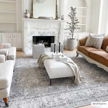 Elegant living room with a Davina Damask Light Gray rug, white fireplace, brown sofa, and neutral furniture. Roomscene-Rectangle