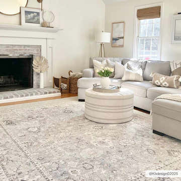 Living room with gray sectional, ottoman, and Davina Damask Sage rug. Farmhouse style with neutral tones. Roomscene-Rectangle