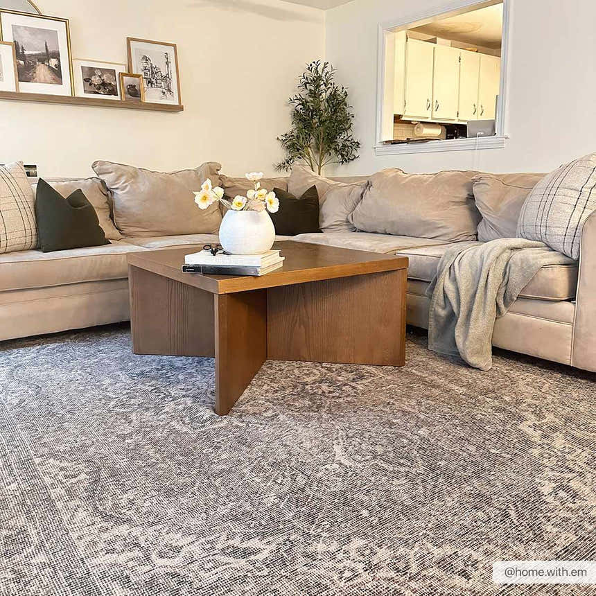 Living room scene with a beige sectional sofa and the Greenpoint Dusty Blue Washable Rug. The rug has a vintage, oriental pattern. Roomscene-Rectangle