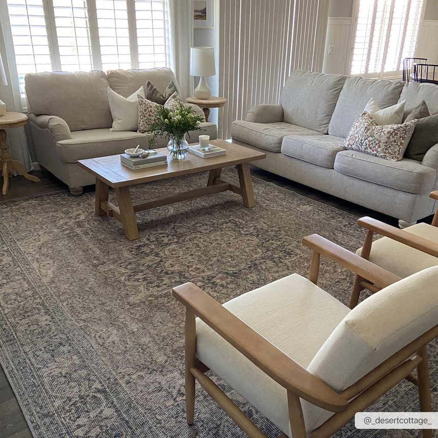 Living room scene with beige sofas and a wood coffee table on a Greenpoint Dusty Blue Washable Rug. Roomscene-Rectangle