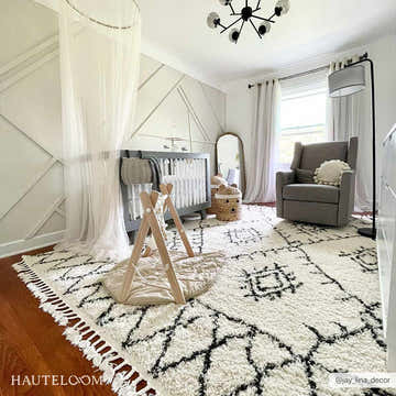 Nursery with Emlenton Berber Shag rug, gray crib, and glider. Black and white Moroccan rug with tassels. Roomscene-Rectangle