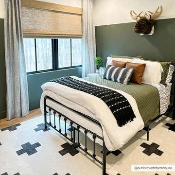 Farmhouse bedroom with Erath Area Rug in white with black plus sign pattern. Black metal bed frame, green accent wall. Roomscene-Rectangle