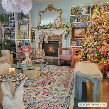 Festive living room with Errol Area Rug, Christmas tree, fireplace, and pink chairs. Roomscene-Rectangle