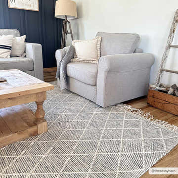 Living room scene with gray armchairs and a geometric Ezria Wool Rug with Tassels in bone and gray. Farmhouse style. Roomscene-Rectangle
