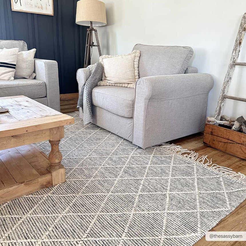 Living room scene with gray armchairs and a geometric Ezria Wool Rug with Tassels in bone and gray. Farmhouse style. Roomscene-Rectangle