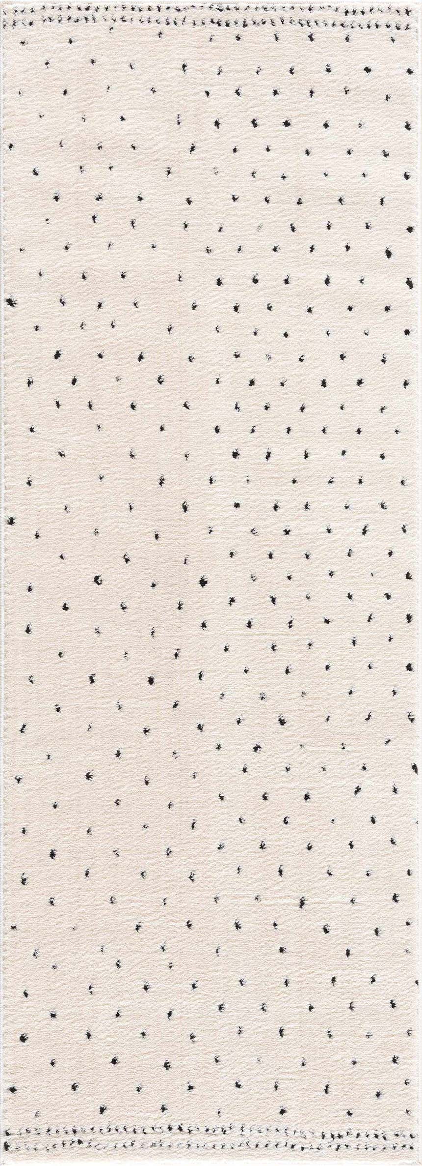 Close-up of the Julie Area Rug. Beige rug with a black polka dot pattern. Contemporary and geometric style. Design-Runner-2773