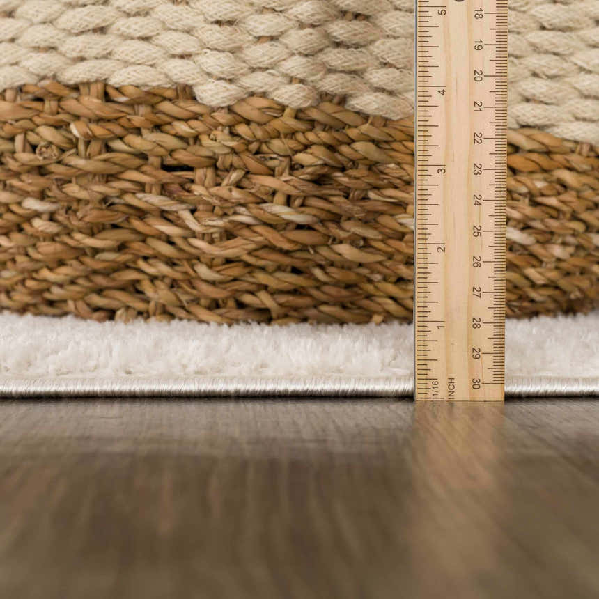 Close-up of the Julio Ivory Area Rug showing its plush texture and pile height with a ruler for scale. Pile