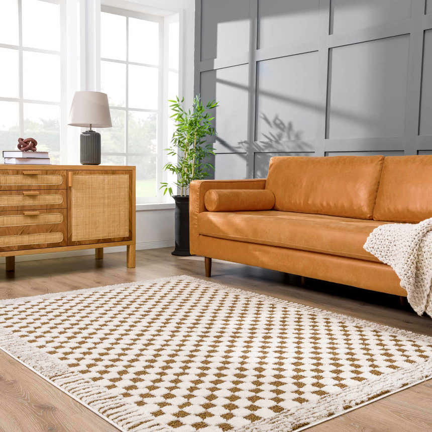 Living room scene with a Leryn Brown Checkered Plush Rug, tan leather sofa, and wood cabinet. Neutral, mid-century modern style. Roomscene-Rectangle