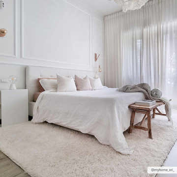 Bright bedroom scene with a Faina Solid Cream Shag Washable Area Rug, white bedding, and sheer curtains. Roomscene-Rectangle