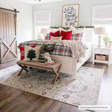 Festive bedroom scene with the beige and gray Georgiana Area Rug, white bed, and red Christmas accents. Roomscene-Rectangle