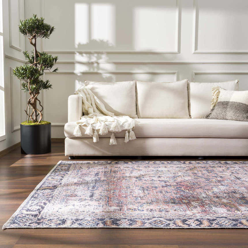 Living room scene with a cream sofa and the burgundy Holi-2305 Boutique Washable Rug on a wood floor. Roomscene-Rectangle