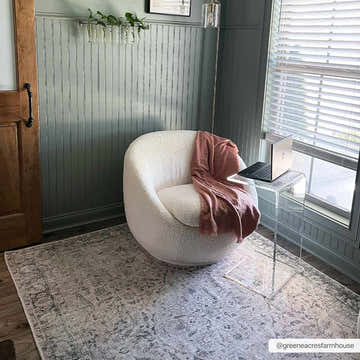 Home office with Haile Green & Pink Washable Area Rug, white chair, pink throw, and laptop on a clear side table. Roomscene-Rectangle