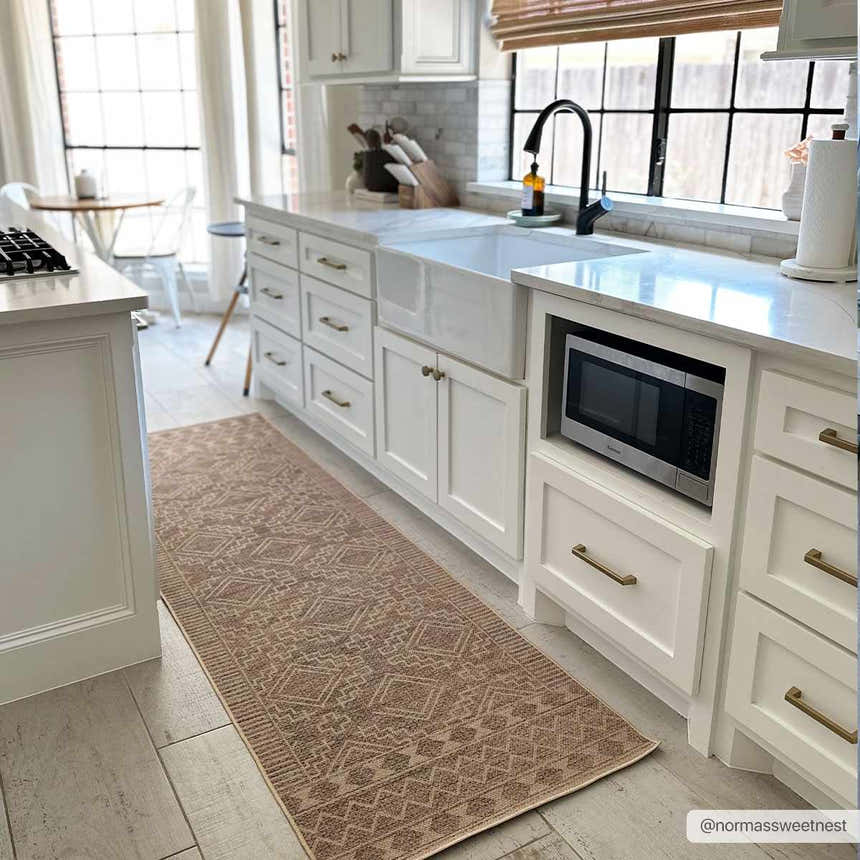 Farmhouse kitchen with white cabinets and Halle Beige Washable Area Rug runner on light wood-look tile. Roomscene-Runner