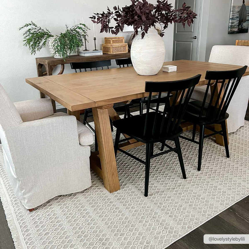 Dining room with light wood table, black chairs, and neutral Hamal Area Rug in cloud gray and cream. Roomscene-Rectangle