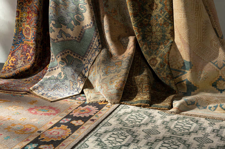 Close-up of Aloleng Area Rugs in light beige, sage, and brown. Hand-knotted wool rugs with traditional, bohemian patterns. Styleshot