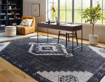 Home office with Siraway Handmade Wool Area Rug, black and light beige, under a modern desk and chair. Roomscene-Rectangle
