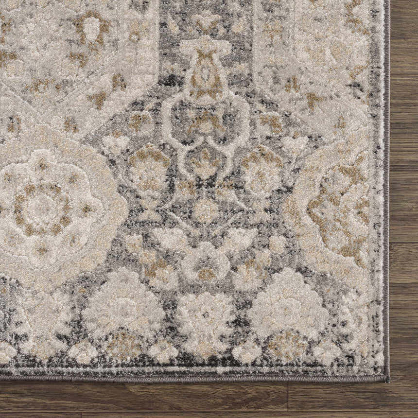 Close-up of the Minoa Area Rug showing beige, black, charcoal, gray, and mustard floral pattern and machine-woven texture. Swatch