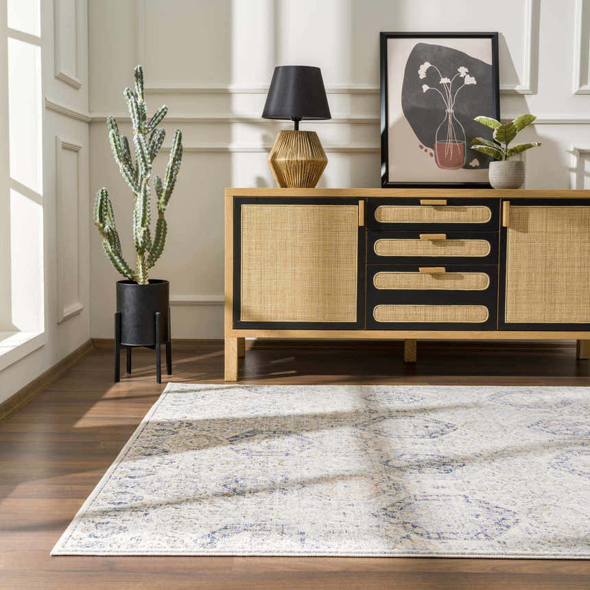 Living room scene with a Parkerfield Cream & Blue Area Rug, wood floors, and a stylish cabinet with decor. Roomscene-Rectangle