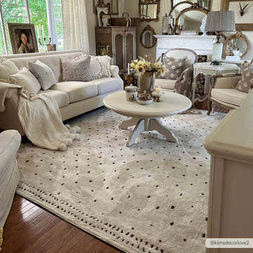 Living room with Julie Ivory & Brown area rug, beige sofa, round coffee table, and farmhouse decor. Roomscene-Rectangle