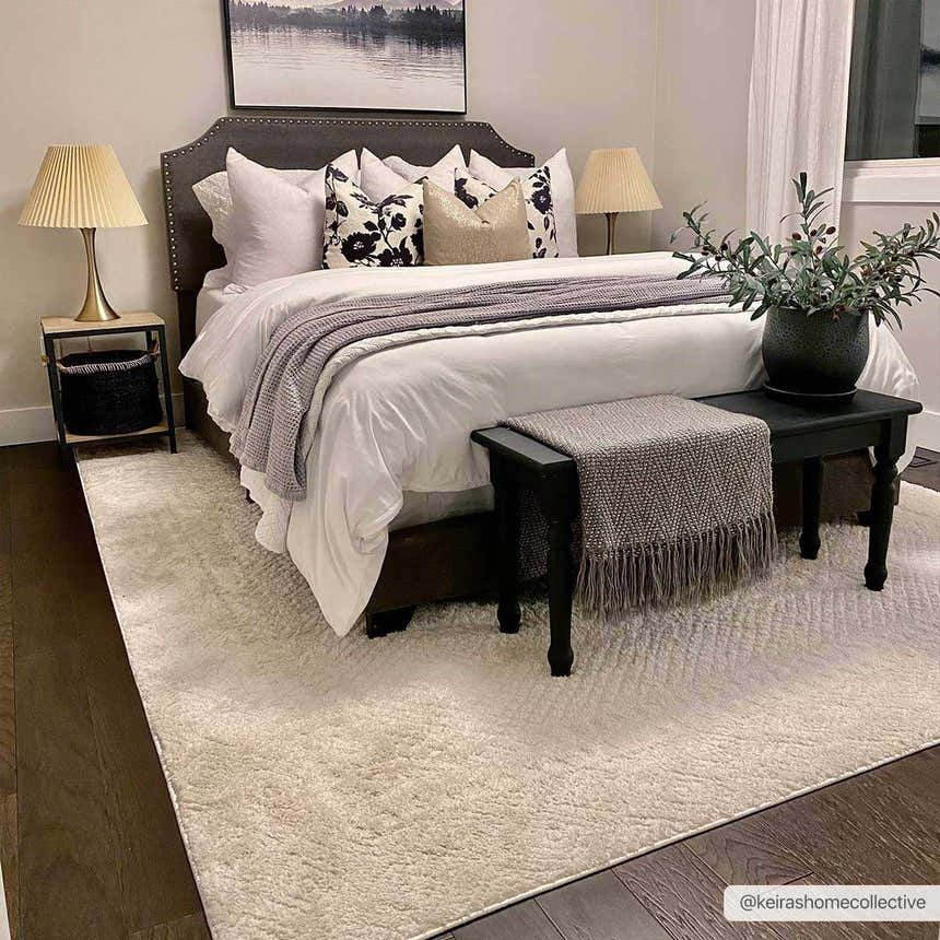 Serene bedroom with a Julio Ivory Area Rug, dark wood floors, and a gray upholstered bed. Roomscene-Rectangle