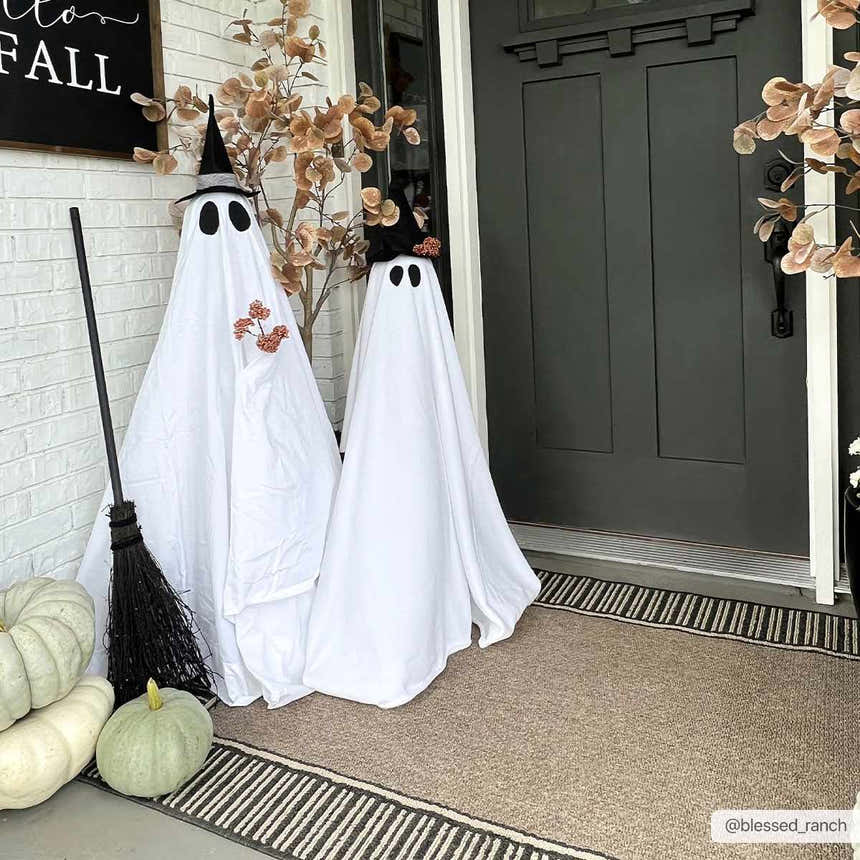 Fall porch scene with ghosts on a Kidron Area Rug. Beige rug with black stripes complements Halloween decor. Roomscene-Rectangle