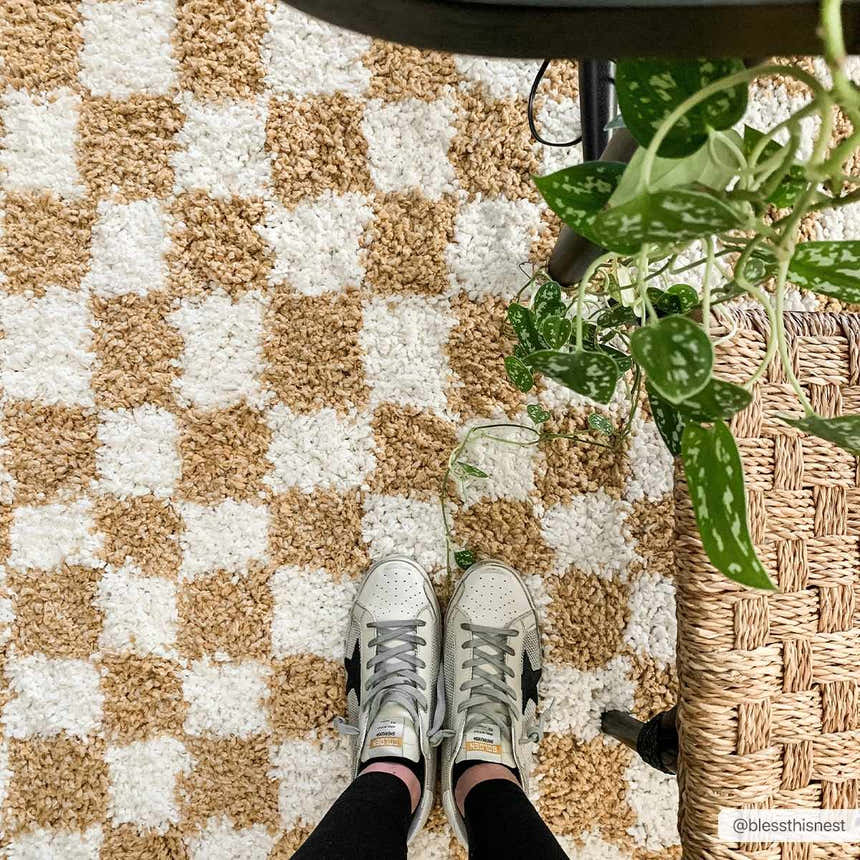 Close-up of the shaggy Kieu Mustard & Ivory Checkered Area Rug, with a checkered pattern and neutral tones. Roomscene-Rectangle