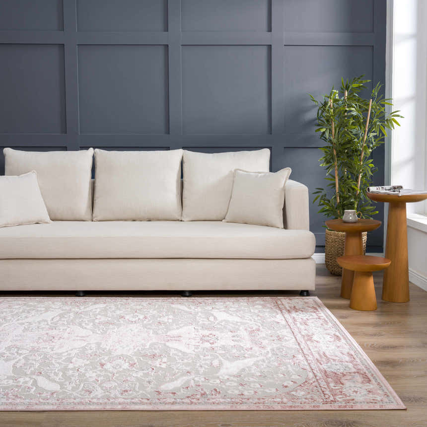 Living room scene with a Zora Pink Area Rug, cream sofa, and gray accent wall. Roomscene-Rectangle
