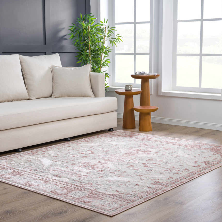 Living room scene with a Zora Pink Area Rug, beige sofa, and wooden side tables. Roomscene-Rectangle