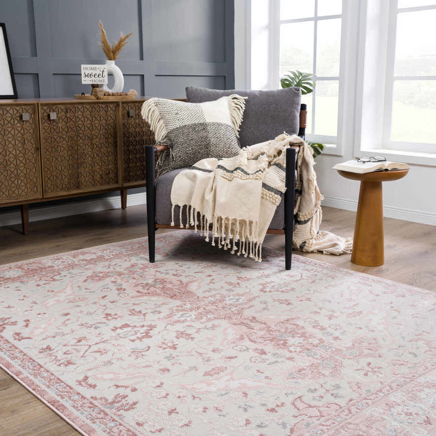 Living room scene with a Zora Pink Area Rug, gray chair, wood cabinet, and neutral accents. Roomscene-Rectangle