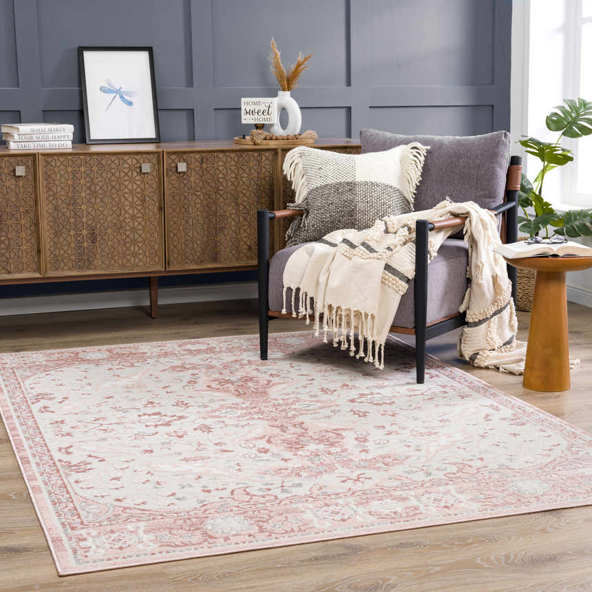Living room scene with a Zora Pink Area Rug, gray chair, wood cabinet, and neutral decor. Roomscene-Rectangle