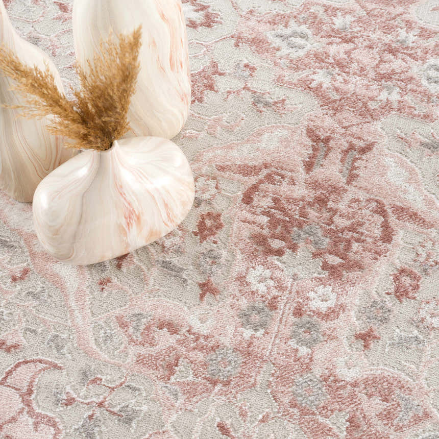 Close-up of Zora Pink Area Rug showing traditional floral design in pink, gray, and cream colors with decorative vases. Styleshot