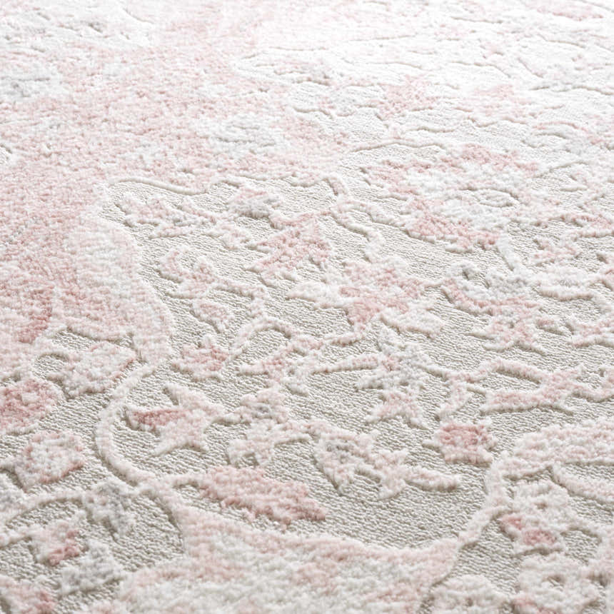 Close-up of the Zora Pink Area Rug showing its traditional floral pattern and soft, textured pile. Texture