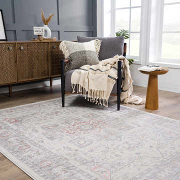 Living room scene with gray armchair and the gray and pink vintage Damla Area Rug. Roomscene-Rectangle