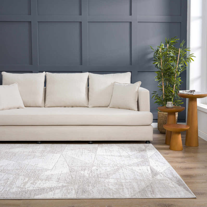 Living room with a light sofa and gray Basia Area Rug featuring a geometric pattern. Roomscene-Rectangle
