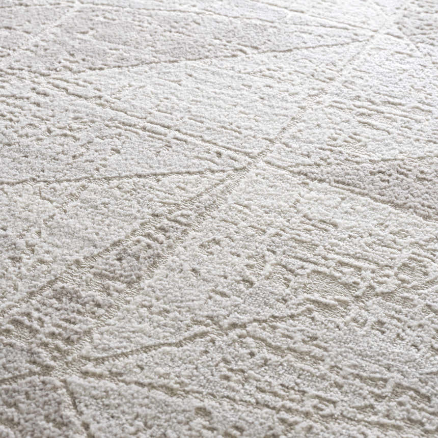 Close-up of the light gray Basia Area Rug, showcasing its geometric pattern and soft, textured pile. Texture
